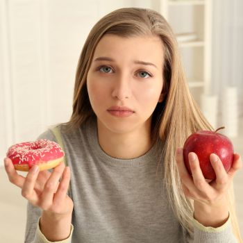 girl choosing between healthy and unhealthy diet