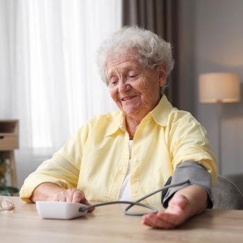 senior checks blood pressure for cardio vascular screening