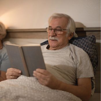 Senior reading at before sleep time instead of watching a screen