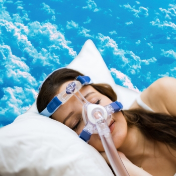 Woman sleeping peacefully with a cpap machine for sleep apnea.